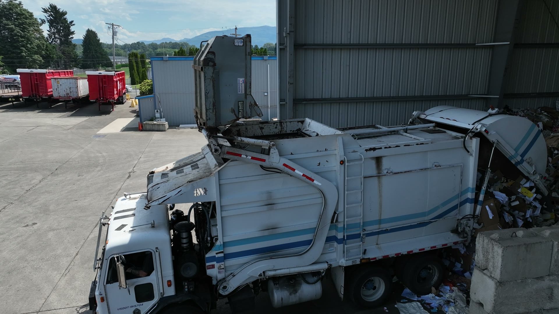 Refuse truck dumping paper and cardboard for recycling